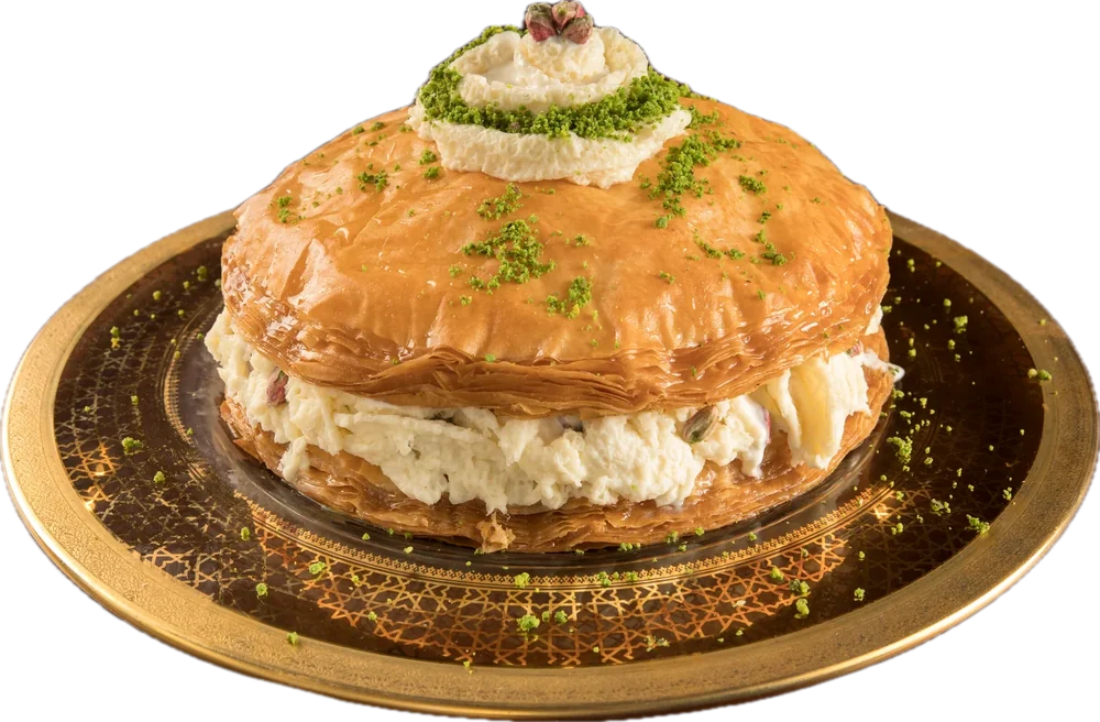 Layered pastry filled with clotted cream on a gilt openwork plate.