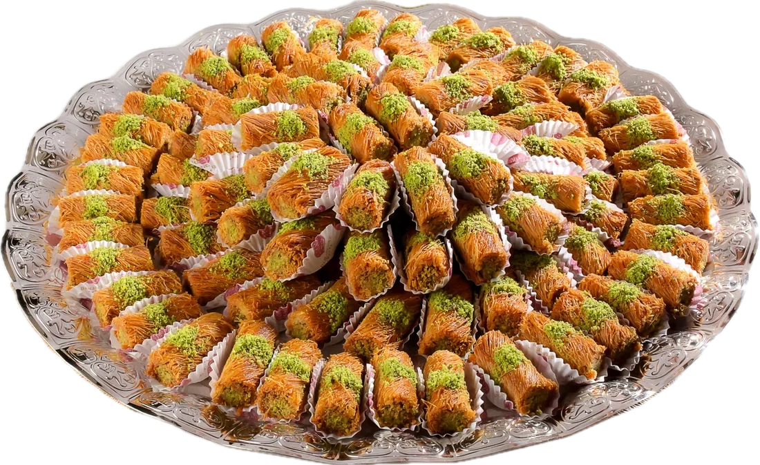 Mabroumeh rolls arranged as a spiral rosette on a scalloped glass platter.